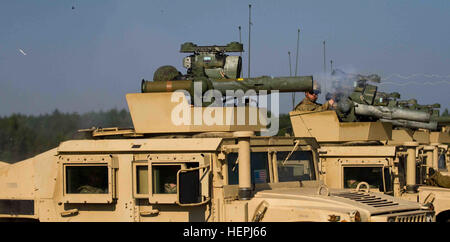 Lithuanan Land Forces Pfc. Savulis Auiuas, a native of Marijampole, Lithuania assigned to Grand Duchess Birutė Uhlan Battalion (BUB), stationed in Alytus, fires a U.S. Army BGM-71 TOW (Tube-launched, Optically-tracked, Wire- Guided) anti-tank missile, which uses the M41 ITAS (Improved Target Acquisition Sight) as it operational base, from atop one of several High Mobility Multipurpose Wheeled Vehicles (HMMWV) operated by Dog Company, 1st Battalion (Airborne), 503rd Infantry Regiment, 173rd Infantry Brigade Combat Team (Airborne), 4th Infantry Division, stationed in Vicenza, Italy and currently Stock Photo