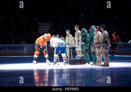 The 9th Civil Support Team's Talon robot drops the ceremonial first puck before the Anaheim Ducks' Veterans Day game against the Edmonton Oilers. The Ducks' tribute also included Cal Guard Special Forces soldiers rappelling from the rafters and driving a tactical vehicle on the ice, among other Cal Guard elements. 'Johnny Five' keeps 9th CST members out of hot zone, Cal Guard pilot program tests robot for chemical, biological, radiological, nuclear response 151111-A-AB123-001 Stock Photo