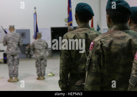 Turkish soldiers assigned to the Multinational Battle Group-East Southern Command Post stand in formation alongside the incoming and outgoing U.S. Army battalions during SCP’s transition of authority ceremony, Feb. 29, 2016, at Camp Bondsteel, Kosovo. The outgoing 1st Battalion, 169th Aviation Regiment, part of the Connecticut Army National Guard, completed a nine-month tour in support of NATO’s Kosovo Force peace support mission, and is replaced by Task Force Red Hawks, led by the Arizona National Guard’s 2-285th Attack Helicopter Battalion, out of Phoenix. (U.S. Army photo by Sgt. Gina Russe Stock Photo