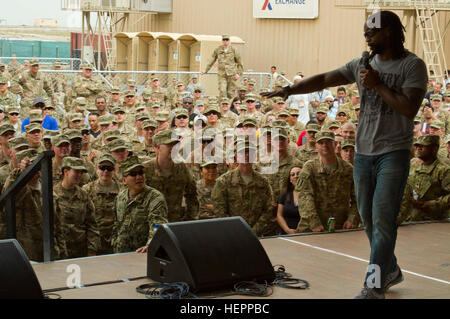 NFL cornerback Charles Tilliman addresses the audience during the USO’s 75th Anniversary Spring Tour at Camp Arifjan, Kuwait, March 15, 2016. Tillman answered questions, threw footballs to the audience and thanked service members for their service to the U.S. (U.S. Army photo by Sgt. Youtoy Martin, U.S. Army Central Public Affairs) USO marks 75 years of bringing parts of home to the troops 160315-A-DP082-045 Stock Photo