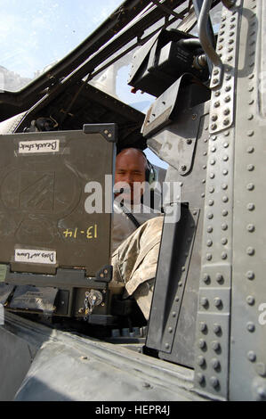 CAMP TAJI, Iraq – Spc. James Gibbon, maintainer, Company B, 404th Aviation Support Battalion, Combat Aviation Brigade, 4th Infantry Division, Multi-National Division – Baghdad from Koror, Palau, checks to make sure everything is working properly inside the cockpit of an Apache attack helicopter on Camp Taji Sept. 18.  (U.S. Army photo by Sgt. 1st Class Brent Hunt, CAB PAO, 4th Inf. Div., MND-B) Maintainers keep CAB war birds in tip-top shape 116426 Stock Photo