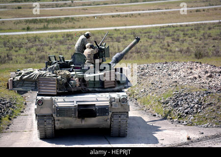 A tank crew from 2nd Battalion, 7th Infantry Regiment loads the M2 .50 Caliber Common Remotely Operated Weapon Station in preparation for Tank Gunnery Table VI at Grafenwoehr Training Area, Germany April 29. The battalion is qualifying tank crews, sections and platoons to make sure they have trained and lethal formations for Exercise Anakonda 16. Anakonda 16 is a Polish-led exercise taking place in Poland June 7-17 with more than 25,000 participants from 24 nations, supporting assurance and deterrence measures by demonstrating Allied defense capabilities to deploy, mass and sustain combat powe Stock Photo