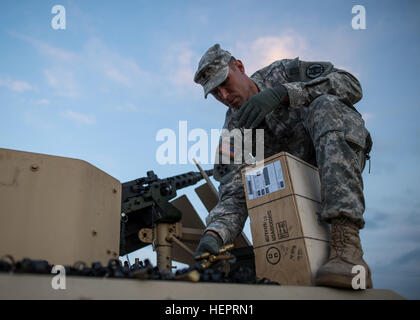 Spc. Trenton Beck, of Marysville, California, a U.S. Army Reserve military police Soldier from the 341st MP Company, of Mountain View, California, picks up .50-caliber shell casings off a vehicle roof after a M2 Bradley firing table at Fort Hunter-Liggett, California, May 3. The 341st MP Co. is one of the first units in the Army Reserve conducting a complete 6-table crew-serve weapon qualification, which includes firing the M2, M249 and M240B machine guns both during the day and night. (U.S. Army photo by Master Sgt. Michel Sauret) Army Reserve MPs mount up with crew-served firepower 160503-A- Stock Photo