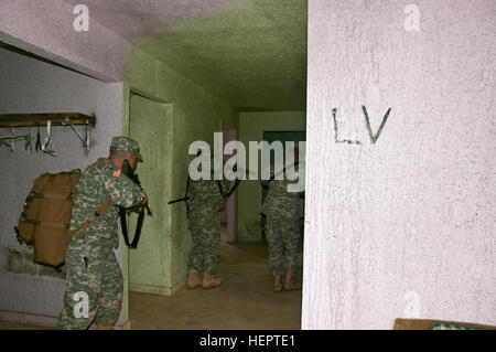 Soldiers of the 377th Detachment, 377th Company, and 377th Battalion out of Cincinnati, Ohio, tactically move to clear a house during a Situational Training Exercise at Muscatatuck Urban Training Center, Ind., May 14th 2016. The training is part of the 377th Detachment, 377th Company, and 377th Battalion Battle Assembly to test the MPs knowledge and ability to react to realistic scenarios they may encounter in a deployed environment. (Photo by US Army Sgt. Marco Gutierrez.) Realistic Training for Military Police (Image 1 of 11) 160514-A-GT254-007 Stock Photo