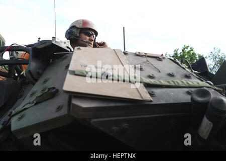 A U.S. Soldier of Alpha Company, 5th Battalion, 7th Cavalry Regiment provides security from a M2 Bradley Fighting Vehicle while conducting a cordon and search scenario during exercise Combined Resolve VI at the U.S. Army’s Joint Multinational Readiness Center in Hohenfels, Germany, May 23, 2016. Exercise Combined Resolve VI is designed to exercise the U.S. Army’s regionally allocated force to the U.S. European Command area of responsibility with multinational training at all echelons. Approximately 570 participants from 5 NATO and European partner nations will participate. The exercise involve Stock Photo