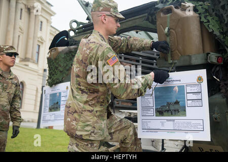 U.S. Army Pvt. Brock Lerdall, an Infantryman with 4th Squadron, 2nd Cavalry Regiment sets up an information poster about his Stryker Armored Fighting Vehicle, at a static display in front of the Dresden Military Museum, Dresden, Germany, May 31, 2016, during Dragoon Ride II, a 2,200 kilometer convoy to Estonia for Exercise Saber Strike 2016. Exercise Saber Strike 2016 is a U.S. Army Europe-led cooperative training exercise designed to improve joint interoperability to support multinational contingency operations. (U.S. Army photo by Staff Sgt. Ricardo HernandezArocho/Released) Saber Strike 201 Stock Photo