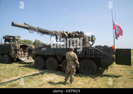 U.S. Soldiers assigned to 4th Squadron, 2nd Cavalry Regiment during Dragoon Ride II, off-load their Stryker Armored Fighting Vehicles after arriving in a staging area near Bydgoszcz, Poland, June 5, 2016. Dragoon Ride II, is the 2,200 kilometer convoy to Estonia in preparation for Exercise Saber Strike 2016, a U.S. Army Europe-led cooperative training exercise designed to improve joint interoperability to support multinational contingency operations. (U.S. Army photo by Staff Sgt. Ricardo HernandezArocho/Released) Dragoon Ride II Powidz to Bydgoszcz, Poland 160605-A-DM872-227 Stock Photo