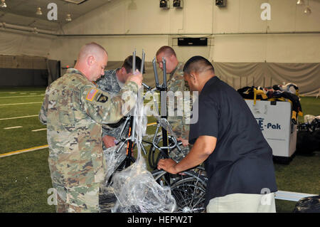 Soldiers from the Warrior Transition Command unwrap a racing cycle  in perparation for issue for the 2016 Department of Defense Warrior Games being held at the United States Military Academy at West Point, N.Y., June 6, 2016. The DoD Warrior Games, June 15-21, is an adaptive sports competition for wounded, ill and injured service members and Veterans. Athletes representing teams from the Army, Marine Corps, Navy, Air Force, Special Operations Command and the British Armed Forces compete in archery, cycling, track and field, shooting, sitting volleyball, swimming, and wheelchair basketball. (US Stock Photo