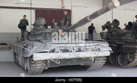 Slovenian soldiers of 45th Center for Tracked Combat Vehicles (CGBV) attach the Multiple Integrated Laser Engagement Systems (MILES) onto an M-84 main battle tank during Swift Response 16 training exercise at the Hohenfels Training Area, a part of the Joint Multinational Readiness Center, in Hohenfels, Germany, Jun. 8, 2016. Exercise Swift Response is one of the premier military crisis response training events for multi-national airborne forces in the world. The exercise is designed to enhance the readiness of the combat core of the U.S. Global Response Force – currently the 82nd Airborne Divi Stock Photo