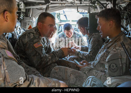 U.S. Soldiers assigned to 4th Squadron, 2nd Cavalry Regiment during Dragoon Ride II, spend their down time playing an electronic board game inside their Stryker Armored Fighting Vehicle after a convoy from Liervalde, Lativia to Parnu Estonia, June 14, 2016. Dragoon Ride II, is the 2,200 kilometer convoy to Estonia in preparation for Exercise Saber Strike 2016, a U.S. Army Europe-led cooperative training exercise designed to improve joint interoperability to support multinational contingency operations. (U.S. Army photo by Staff Sgt. Ricardo HernandezArocho/Released) Dragoon Ride II Convoy to P Stock Photo