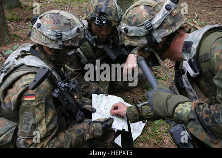 Soldiers of the German Bundeswehr patrol in tanks the training village ...