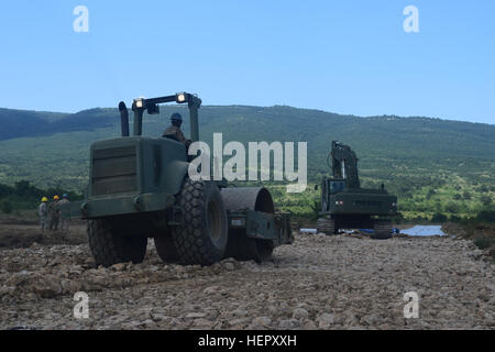 Heavy construction equipment operated by military engineers from the Tennessee and Mississippi Army National Guard extend a tank firing range at Novo Selo Training Area, Bulgaria during Operation Resolute Castle on June 25, 2015.  Maj. Gen. Max Haston, The Adjutant General for the State of Tennessee came to Novo Selo Training Area to review the progress of the 194th Engineer Brigade on June 28, 2016.  (U.S. Army photo by 1st Lt. Matthew Gilbert, 194th Engineer Brigade, Tennessee Army National Guard) The Adjutant General, Tennessee National Guard, Visits Deployed Soldiers in Bulgaria 160625-A-C Stock Photo