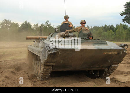 TRZEBIEN, Poland – Cpl. Aaron Brixley, tank gunner, and Pfc. Nathaniel Pinson, tank loader, both with Company D, 3rd Combined Arms Battalion, 69th Armor Regiment, 3rd Infantry Division, ride in a Polish BMP infantry fighting vehicle during joint training operations Aug. 2 in Trzebien, Poland. The D Co. “Dark Knights” joined Polish soldiers of the 10th Armoured Cavalry Brigade, 11th Armoured Division, to conduct joint vehicle training to better understand each other’s capabilities. The D Co. “Dark Knights” stationed out of Fort Stewart, Ga., are currently on a training rotation in support of Op Stock Photo