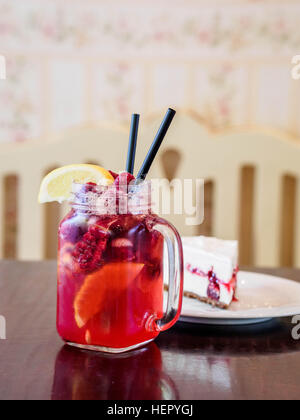 Raspberry lemonade and slice of cheesecake Stock Photo