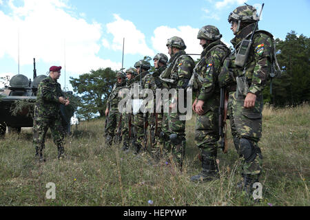 Romanian soldiers of the 33rd Mountain Battalion Posada receive a mission brief while conducting a Distinguished Visitors tour during exercise Combined Resolve VII at the U.S. Army’s Joint Multinational Readiness Center in Hohenfels Germany, Sept. 6, 2016. Combined Resolve VII is a 7th Army Training Command, U.S. Army Europe-directed exercise, taking place at the Grafenwoehr and Hohenfels Training Areas, Aug. 8 to Sept. 15, 2016. The exercise is designed to train the Army’s regionally allocated forces to the U.S. European Command. Combined Resolve VII includes more than 3,500 participants from Stock Photo