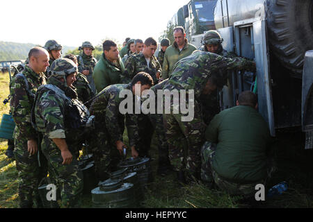 Romanian soldiers of the 33rd Mountain Troop Battalion, 2nd Mountain Brigade refill water containers while conducting resupply operations during exercise Combined Resolve VII at the U.S. Army’s Joint Multinational Readiness Center in Hohenfels Germany, Sept. 7, 2016. Combined Resolve VII is a 7th Army Training Command, U.S. Army Europe-directed exercise, taking place at the Grafenwoehr and Hohenfels Training Areas, Aug. 8 to Sept. 15, 2016. The exercise is designed to train the Army’s regionally allocated forces to the U.S. European Command. Combined Resolve VII includes more than 3,500 partic Stock Photo