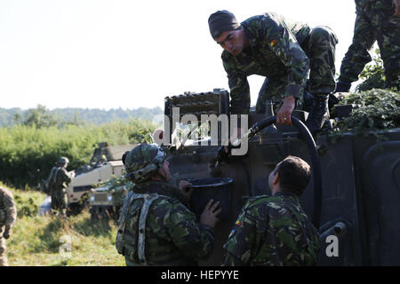 Romanian soldiers of  the 33rd Mountain Troop Battalion, 2nd Mountain Brigade refuels a TAB C-79 armored personnel carrier while conducting resupply operations during exercise Combined Resolve VII at the U.S. Army’s Joint Multinational Readiness Center in Hohenfels Germany, Sept. 7, 2016. Combined Resolve VII is a 7th Army Training Command, U.S. Army Europe-directed exercise, taking place at the Grafenwoehr and Hohenfels Training Areas, Aug. 8 to Sept. 15, 2016. The exercise is designed to train the Army’s regionally allocated forces to the U.S. European Command. Combined Resolve VII includes  Stock Photo