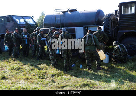 Romanian soldiers of the 33rd Mountain Troop Battalion, 2nd Mountain Brigade refill water containers while conducting resupply operations during exercise Combined Resolve VII at the U.S. Army’s Joint Multinational Readiness Center in Hohenfels Germany, Sept. 7, 2016. Combined Resolve VII is a 7th Army Training Command, U.S. Army Europe-directed exercise, taking place at the Grafenwoehr and Hohenfels Training Areas, Aug. 8 to Sept. 15, 2016. The exercise is designed to train the Army’s regionally allocated forces to the U.S. European Command. Combined Resolve VII includes more than 3,500 partic Stock Photo