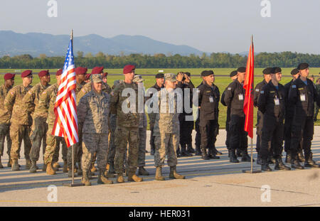 Soldiers and Airmen from the United States stand in formation with multinational partners at the Immediate Response 16 opening ceremony. Immediate Response 16 is a multinational, brigade-level command post exercise utilizing computer-assisted simulations and field training exercises spanning two countries, Croatia and Slovenia. The exercises and simulations are built upon a decisive action based scenario and are designed to enhance regional stability, strengthen Allied and partner nation capacity, and improve interoperability among partner nations. The exercise will occur Sept. 9-23, 2016, and Stock Photo