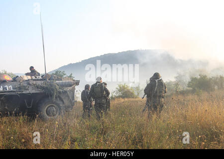 Romanian soldiers of 33rd Romanian Mountain Battalion, 2nd Mountain Troops Brigade regroup while conducting a movement to contact scenario exercise Combined Resolve VII at the U.S. Army’s Joint Multinational Readiness Center in Hohenfels Germany, Sept. 12, 2016. Combined Resolve VII is a 7th Army Training Command, U.S. Army Europe-directed exercise, taking place at the Grafenwoehr and Hohenfels Training Areas, Aug. 8 to Sept. 15, 2016. The exercise is designed to train the Army’s regionally allocated forces to the U.S. European Command. Combined Resolve VII includes more than 3,500 participant Stock Photo