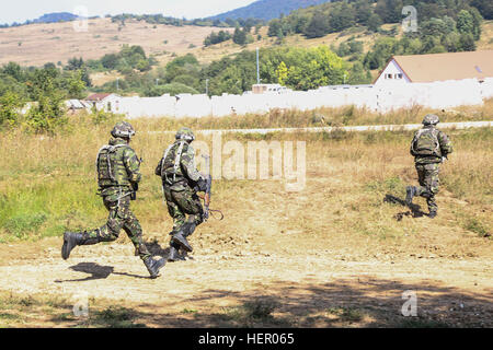 Romanian soldiers of 33rd Romanian Mountain Battalion, 2nd Mountain Troops Brigade move to engage the simulated enemy while conducting a town assault scenario during exercise Combined Resolve VII at the U.S. Army’s Joint Multinational Readiness Center in Hohenfels Germany, Sept. 12, 2016. Combined Resolve VII is a 7th Army Training Command, U.S. Army Europe-directed exercise, taking place at the Grafenwoehr and Hohenfels Training Areas, Aug. 8 to Sept. 15, 2016. The exercise is designed to train the Army’s regionally allocated forces to the U.S. European Command. Combined Resolve VII includes  Stock Photo