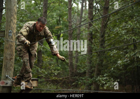 U.S. Army Staff Sgt. Clinton Bahme, assigned to U.S. Army Special Operations Command, maneuvers through an obstacle during the U.S. Army 2016 Best Warrior Competition (BWC) at Fort A.P. Hill, Va., Sept. 27, 2016. The BWC is an annual weeklong event that will test 20 Soldiers from 10 major commands on their physical and mental capabilities. The top NCO and Soldier will be announced Oct. 3, in Washington DC. (U.S. Army photo by Pfc. Jada Owens). Rope Bridge (29986810915) Stock Photo
