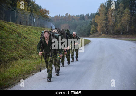 Swedish soldiers participate in the 12 mile Ruck March event as part of the European Best Sniper Squad Competition at the 7th Army Training Command's Grafenwoehr Training Area, Germany, Oct. 27, 2016. The European Best Sniper Squad Competition is an Army Europe competition challenging militaries from across Europe to compete and enhance teamwork with Allies and partner nations. (U.S. Army photo by Spc. Sara Stalvey) 2016 European Best Sniper Squad Competition 161027-A-VL797-031 Stock Photo