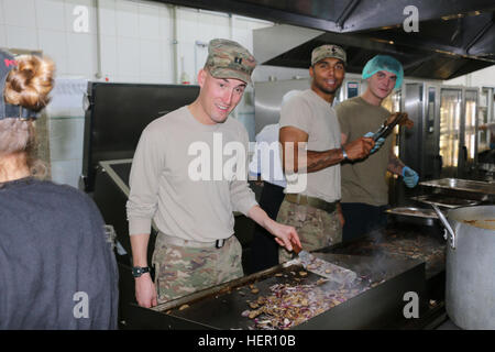 YAVORIV, Ukraine - Capt. Andrew Hibbs, commander of Troop B, 6th Squadron, 8th Cavalry Regiment, 2nd Infantry Brigade Combat Team, 3rd Infantry Division grills shrimp and onions during Thanksgiving food preparation here, November 24, 2016. Senior leaders assisted the Soldiers in planning and cooking for the Thanksgiving celebration. 6-8 CAV is deployed in support of Joint Multinational Training Group-Ukraine whose mission focuses on building a sustainable and enduring training capacity and capability within the Ukrainian land forces.  (U.S.Army photo by Spc. John Onuoha / Released) Mustangs 