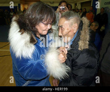 Caroline Hoover proudly pins an Alaska Territorial Guard medal on the front of her father's parka during an official discharge ceremony held Oct. 17 in Kipnuk, Alaska. David Martin is one of three surviving members of the Alaska Territorial Guard's Kipnuk unit. A total of 59 residents of Kipnuk, who volunteered to defend Alaska in the event of a Japanese invasion during World War II, were recognized during the ceremony. Kipnuk residents who served with the Alaska Territorial Guard from 1942-1947 were members of a U.S. Army component organized in response to attacks by the Japanese on Pearl Har Stock Photo