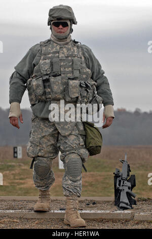 Pfc. James Richardson steps away from his rifle awaiting the orders to take up a good firing position from the control tower at the rifle firing range at Camp Atterbury, Ind., Nov. 12. Fathers, sons, brothers and veterans, Citizen Soldiers ready for war together 130009
