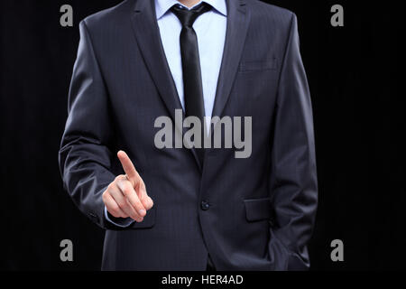 executive man touching an imaginary screen Stock Photo