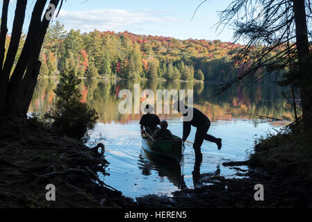 Stepping into a canoe on a trip in the St. Regis Canoe Area of Adirondack State Park, New York. Stock Photo