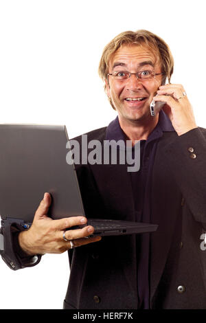 Man talking on mobile phone holding laptop Stock Photo