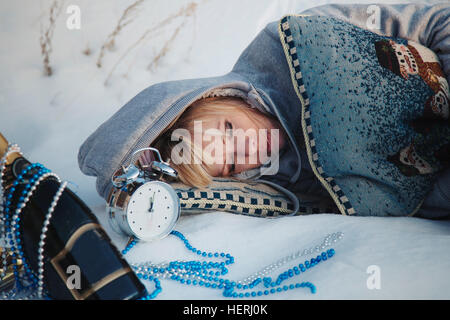 Woman lying in snow sleeping Stock Photo