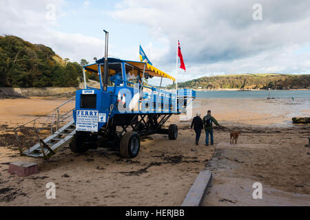 The North Sands to Salcombe Ferry in South Devon.  A tractor/trailer takes passengers out to meet the ferryboat Stock Photo