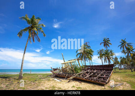 Abandoned fishing boat on a tropical beach, bali, Indonesia Stock Photo