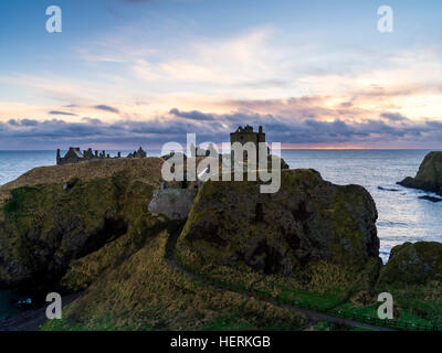 Dunnottar Castle near Aberdeen in North East Scotland is a ruined cliff top fortress  on a rocky outcrop just off the shore. Stock Photo
