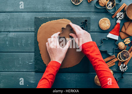 Girl making gingerbread men cookies Stock Photo