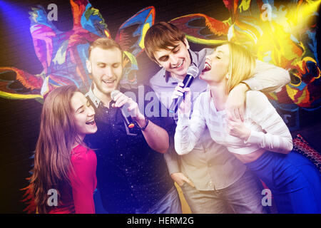 Group happy friends singing karaoke club Stock Photo