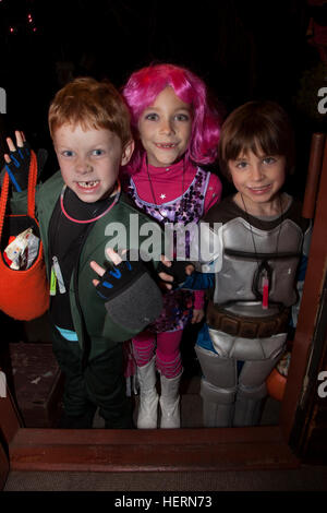 A visit at my front door from galactic Halloween outer space travelers as costumed trick or treaters. St Paul Minnesota MN USA Stock Photo