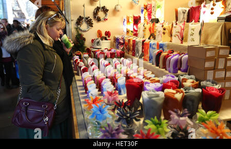 A woman sniffs a scented candle for sale at the South Bank Winter Festival, London as Theresa May has urged Britons not to allow the terror attack on a German Christmas market to stop them enjoying the festive season as usual. Stock Photo