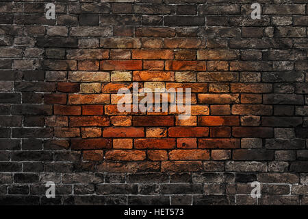 Old brick wall with oval reddish spot in the center Stock Photo