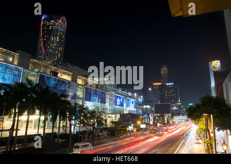 BANGKOK, THAILAND - OCTOBER 13, 2016: View at the Siam square night traffic with light trails. This square is famous shopping area in Bangkok Stock Photo