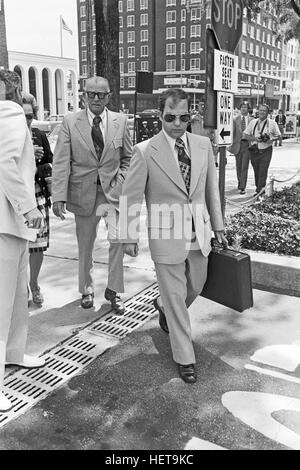 Convicted of the murder of 102 VietNamese civilians  - the My Lai Massacre - former U.S. Army Lieutenant William Calley (sunglasses) is escorted from the Fort Benning, Georgia confinement facility to a federal appeals court in nearby Columbus, Ga. At a later date, Calley's original sentence of life in prison was turned into an order of house arrest, but after three years, President Richard Nixon reduced his sentence with a presidential pardon . Stock Photo