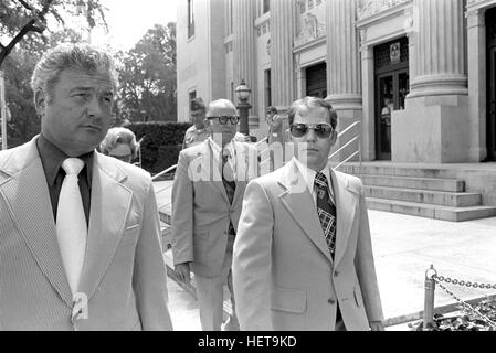 Convicted of the murder of 102 Vietnamese civilians  -the My Lai Massacre - former U.S. Army Lieutenant William Calley (sunglasses) is escorted from the Fort Benning, Georgia confinement facility to a federal appeals court in nearby Columbus, Ga. At a later date, Calley's original sentence of life in prison was turned into an order of house arrest, but after three years, President Richard Nixon reduced his sentence with a presidential pardon. Stock Photo