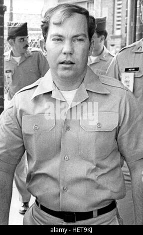 Convicted of the murder of 102 Vietnamese civilians  - the My Lai Massacre -  former U.S. Army Lieutenant William Calley (sunglasses) is escorted from the Fort Benning, Georgia confinement facility to a federal appeals court in nearby Columbus, Ga. At a later date, Calley's original sentence of life in prison was turned into an order of house arrest, but after three years, President Richard Nixon reduced his sentence with a presidential pardon. Stock Photo