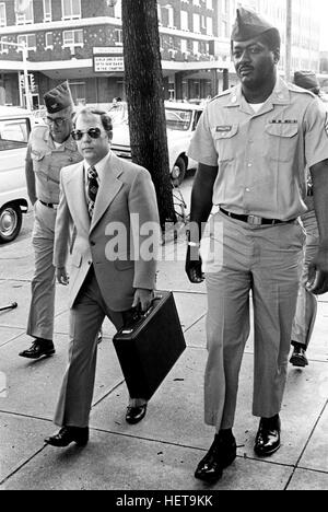 Convicted of the murder of 102 Vietnamese civilians  -the My Lai Massacre - former U.S. Army Lieutenant William Calley (sunglasses) is escorted from the Fort Benning, Georgia confinement facility to a federal appeals court in nearby Columbus, Ga. At a later date, Calley's original sentence of life in prison was turned into an order of house arrest, but after three years, President Richard Nixon reduced his sentence with a presidential pardon. Stock Photo