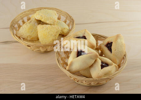 Hamantash and scones in wicker baskets on wooden table Stock Photo