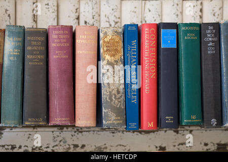 Old books on a wooden shelf Stock Photo