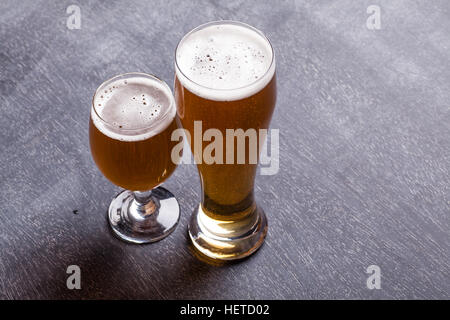Two beer glasses on a classic textured blackboard Stock Photo